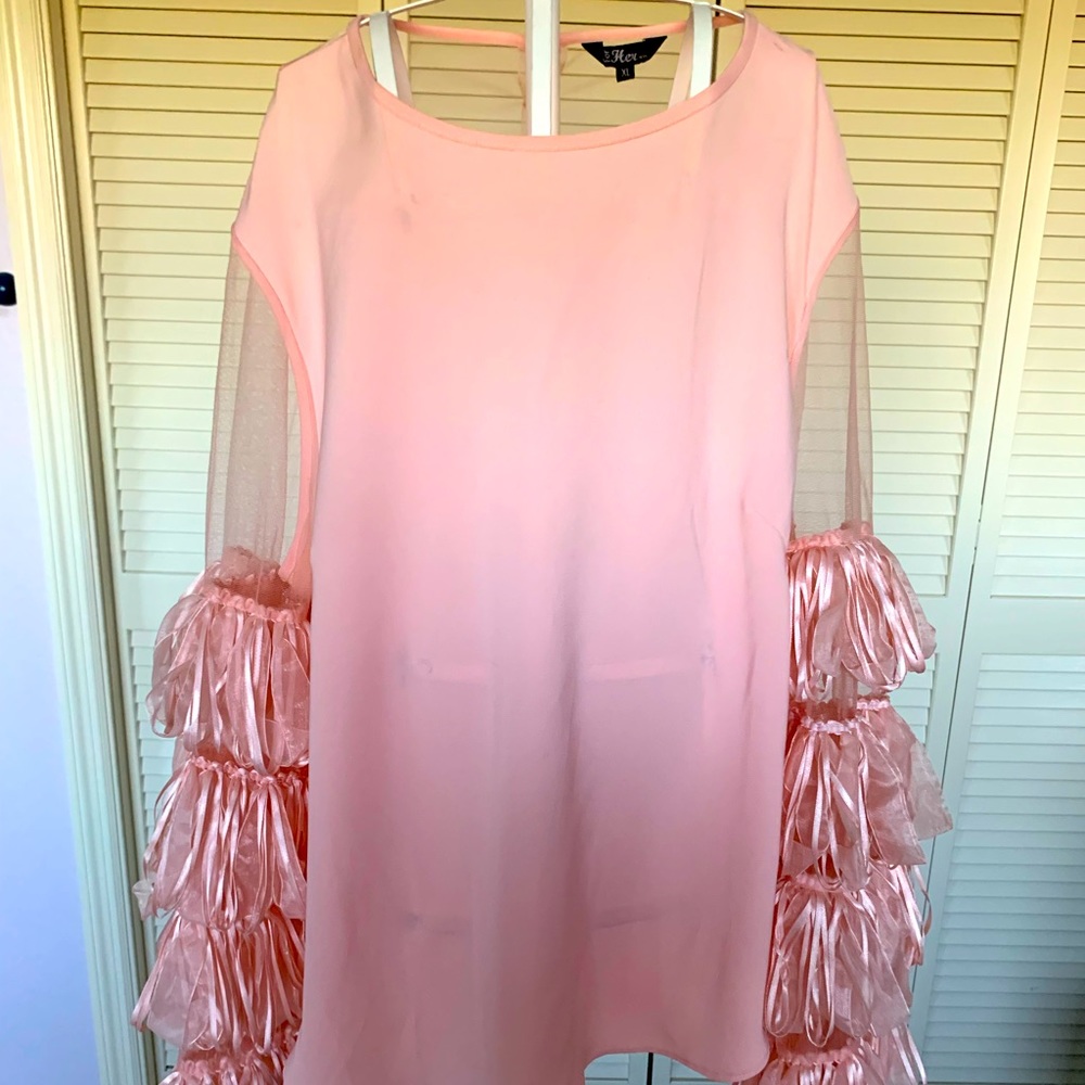 From New York City this beautiful peach blouse is a statement piece